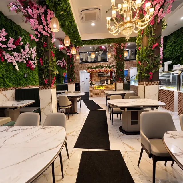 Main dining room with marble tables and a chandelier