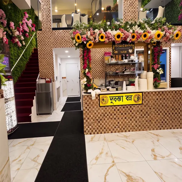 Service counter framed with sunflowers, next to the staircase
