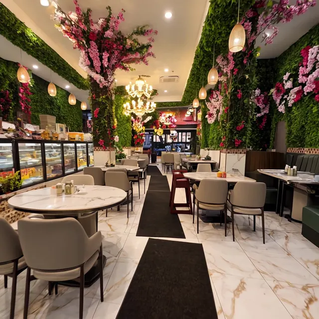 Main dining room seen from the back, toward the dessert cases and front windows